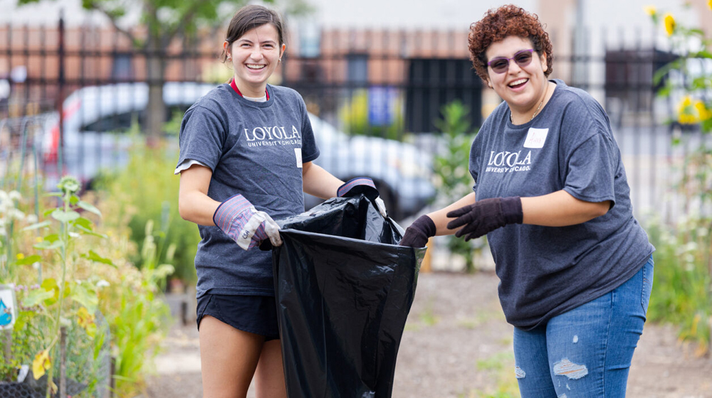 Two students cleaning a park