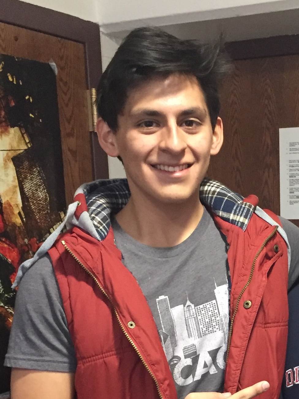 Image of Benjamin Caceres wearing a red vest