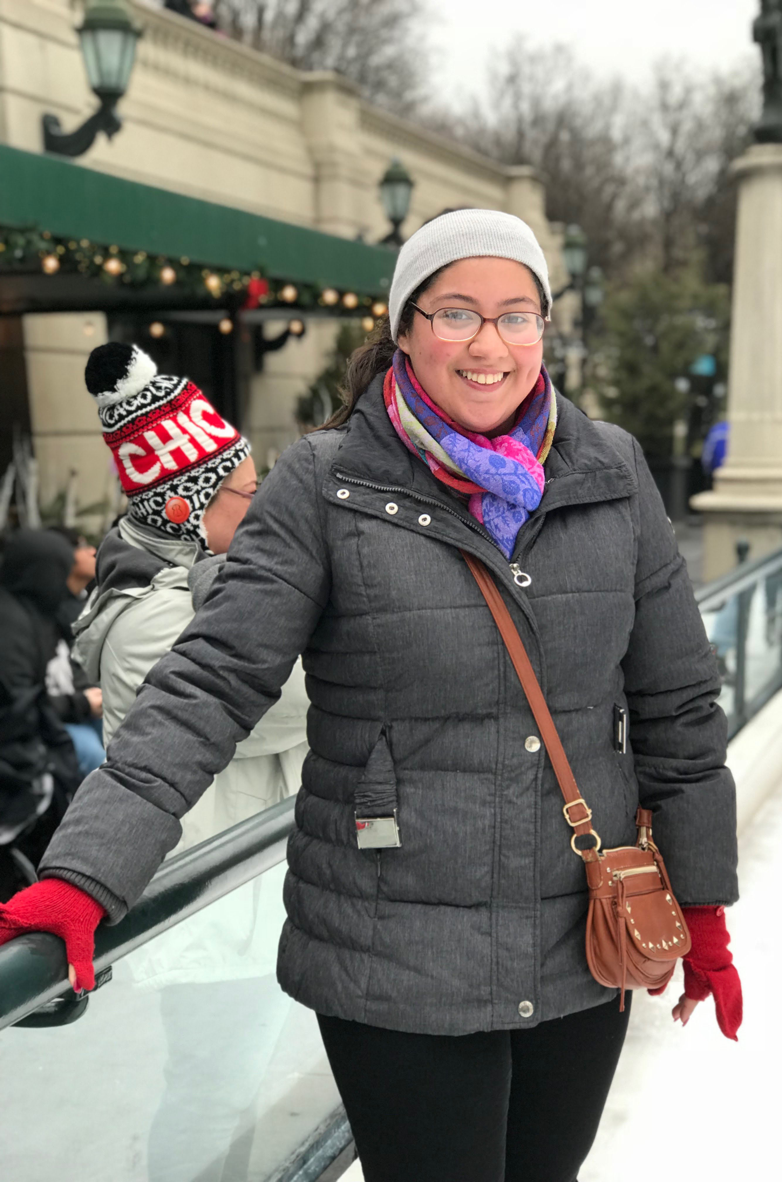 Salena Ibrahim in a winter coat on an ice rink