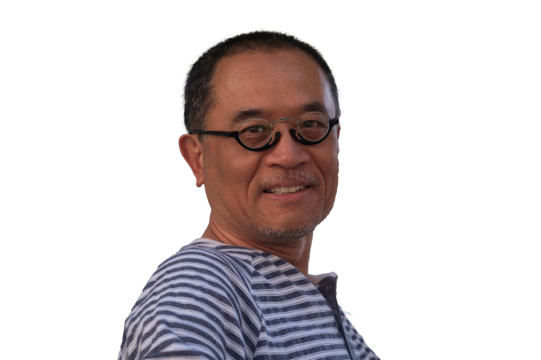 Headshot of a man wearing round glasses and a striped shirt, smiling against a light background