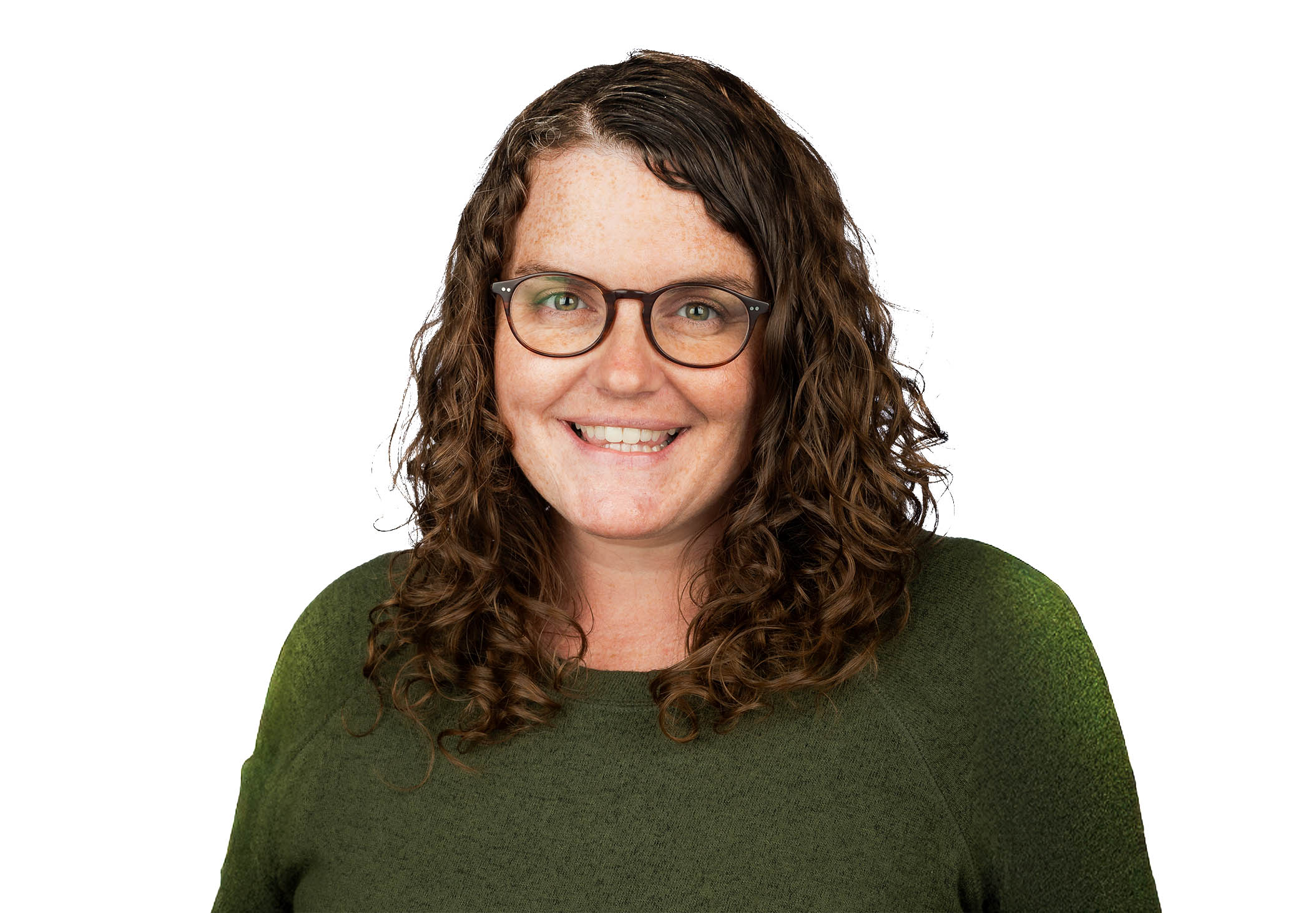 Headshot of a woman with curly hair and glasses smiling, wearing a green top against a light background