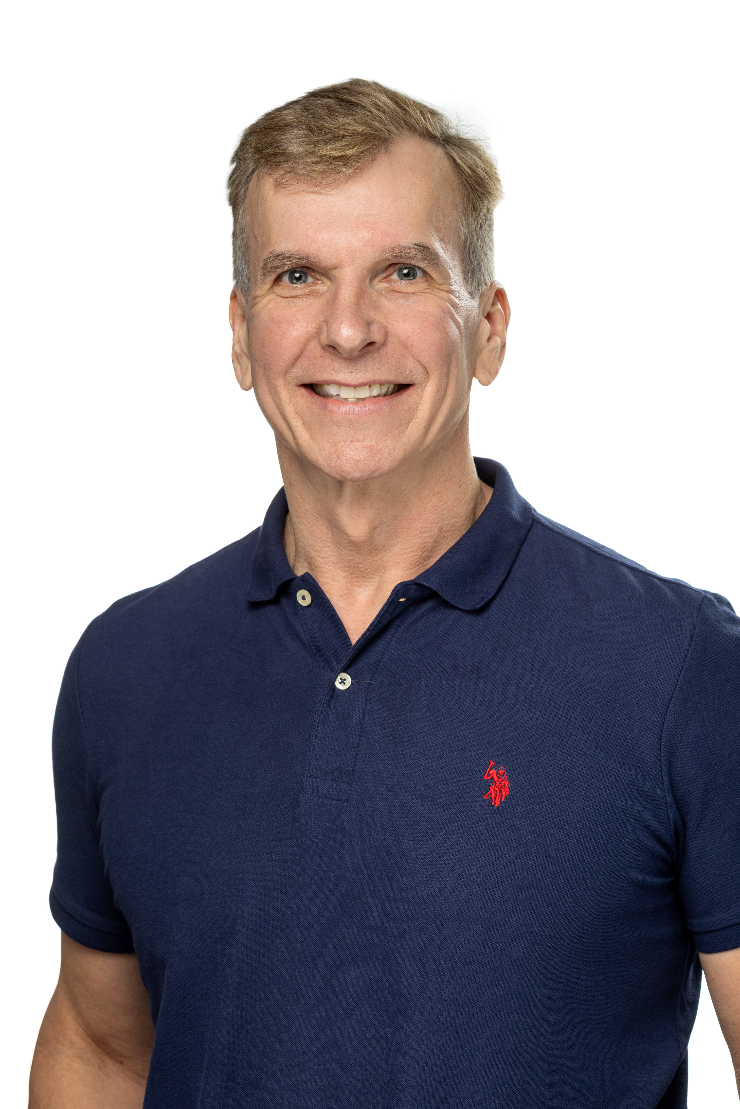 Portrait of John Orwat, PhD, Associate Dean for Faculty Development and Professor, smiling and wearing a navy polo shirt against a light background.