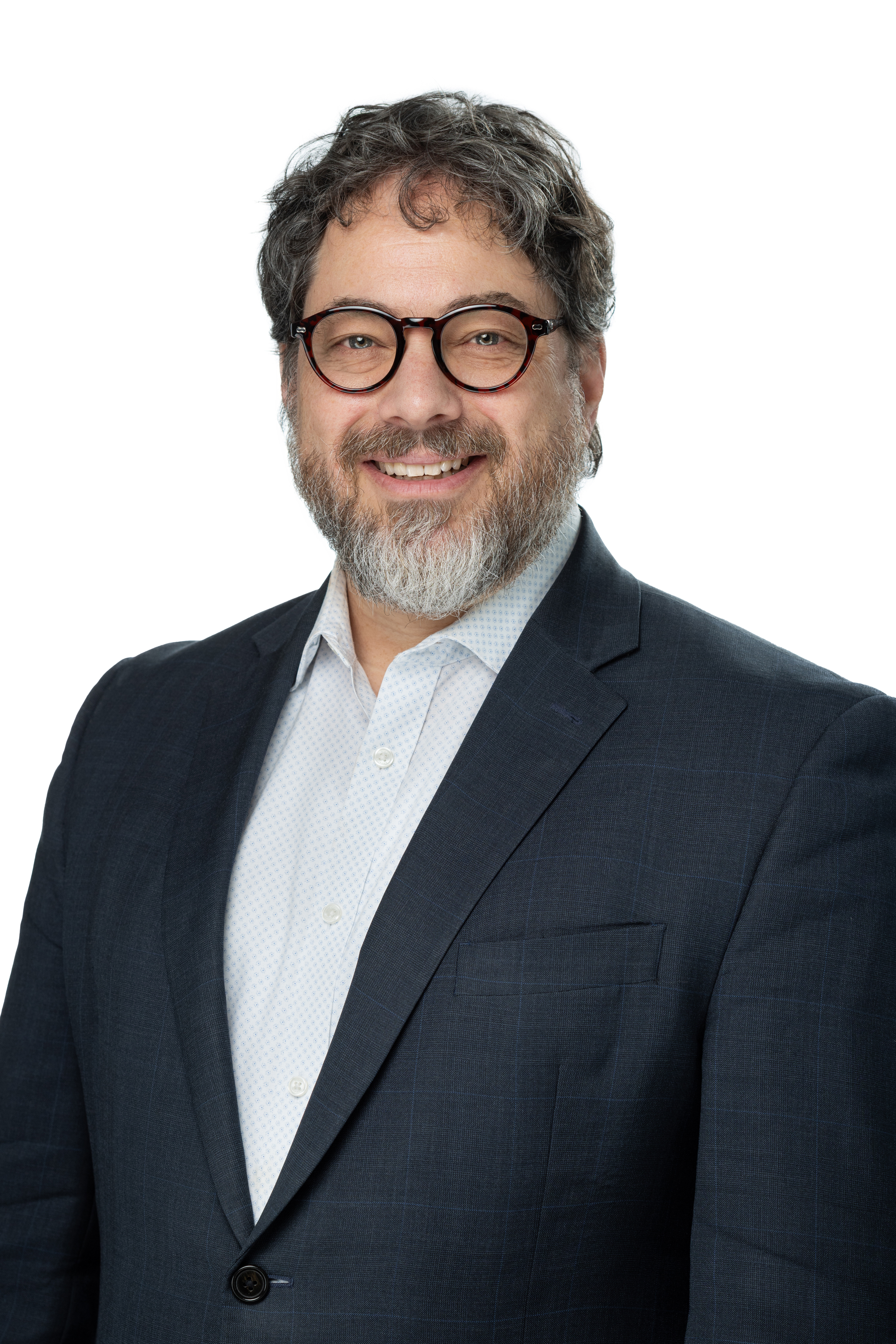 Jonathan B. Singer, Ph.D., LCSW, smiling and wearing round glasses, a dark blazer, and a light patterned shirt, with a salt-and-pepper beard and hair, against a light gray background.