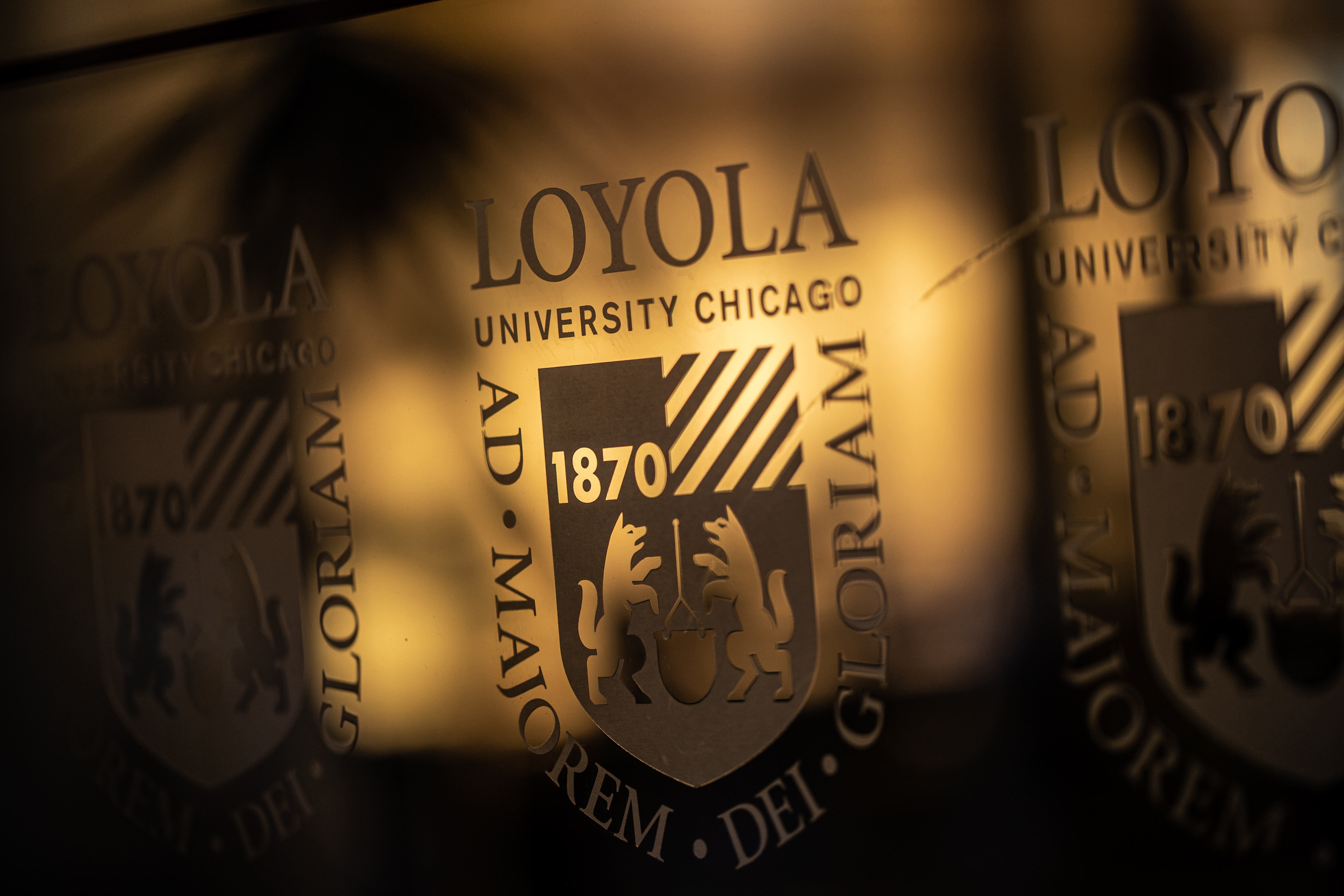 The Loyola University Chicago logo shines in the winter sunrise.