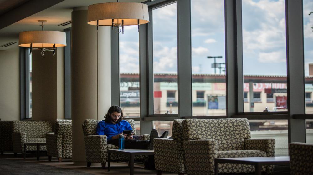 student studying in the damen student center during hours of operation