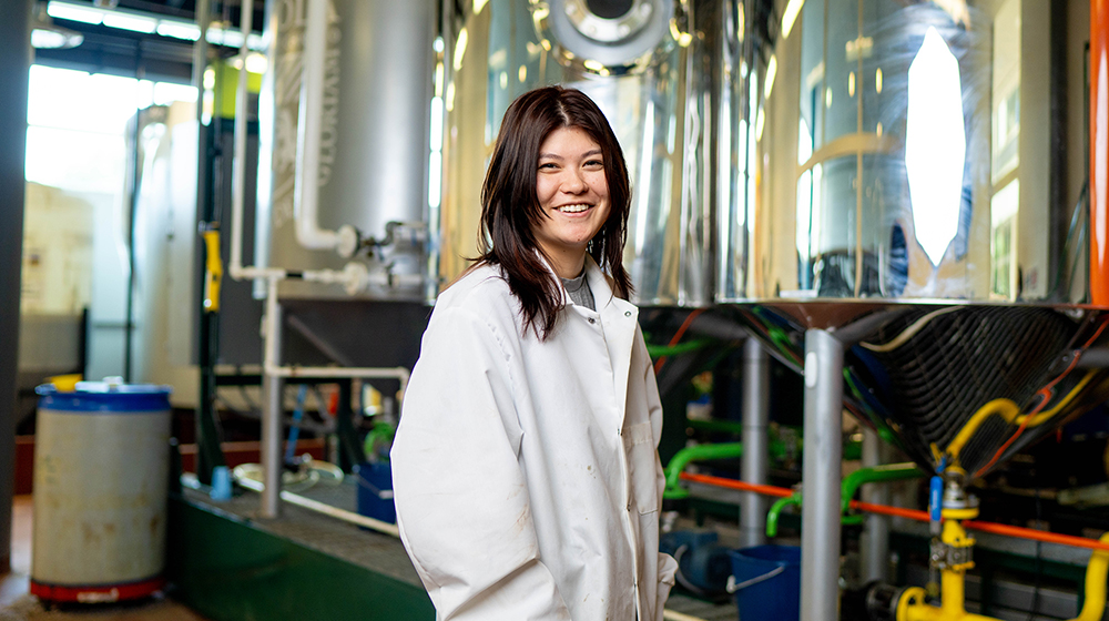 student in a lab coat in the biodiesel lab