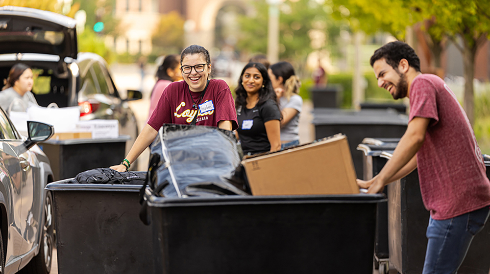 Students pushing bins during move-in 