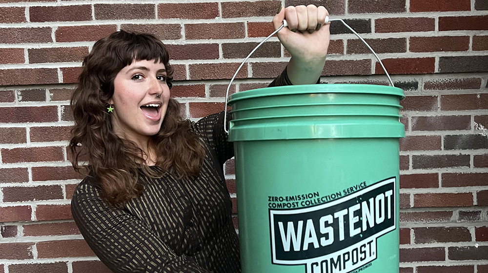 Charlotte Roos holding a compost bucket