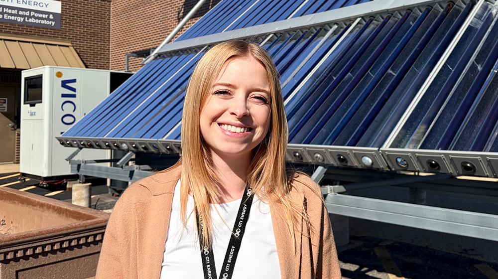 Haley Lim standing in front of a solar panel 