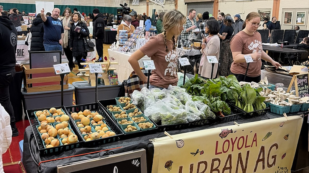 Students staff the urban agriculture stand at the Edgewater Indoor Market