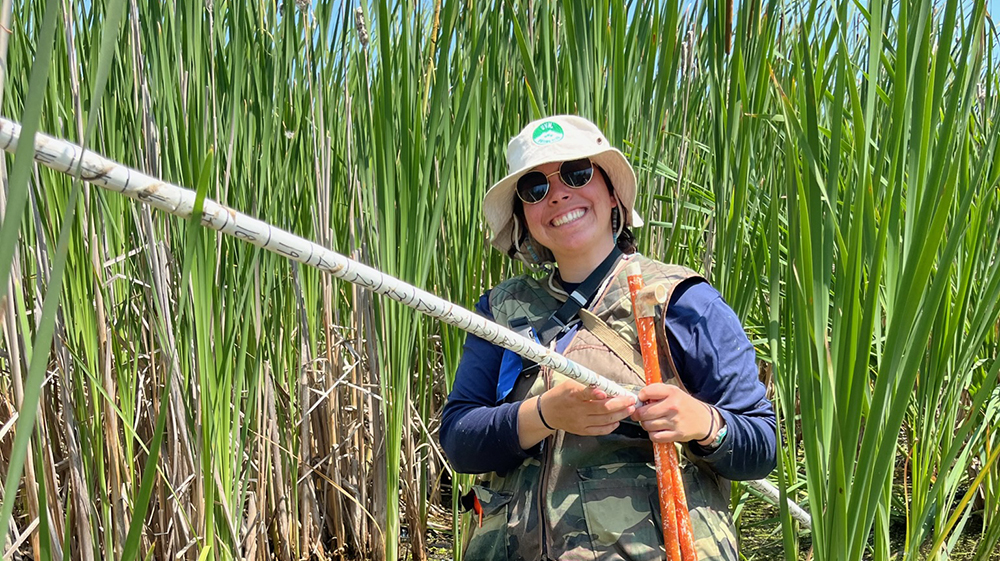 Graduate student MacKenzie Michaels in a wetland