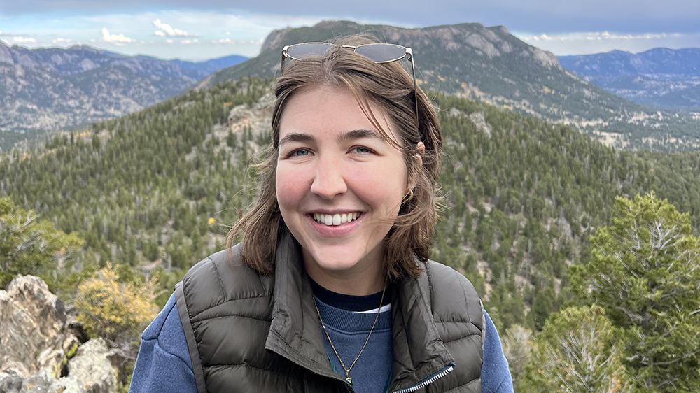 Madi Palmquist in front of mountain scenery