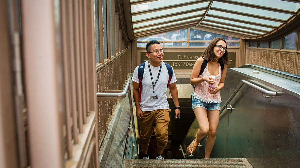 2 students walk up the stairs at the Chicago red line stop