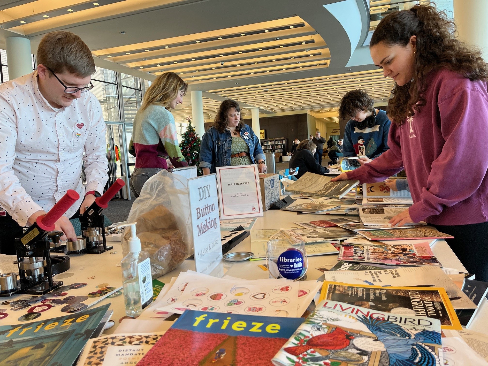 People gathered around a table creating buttons