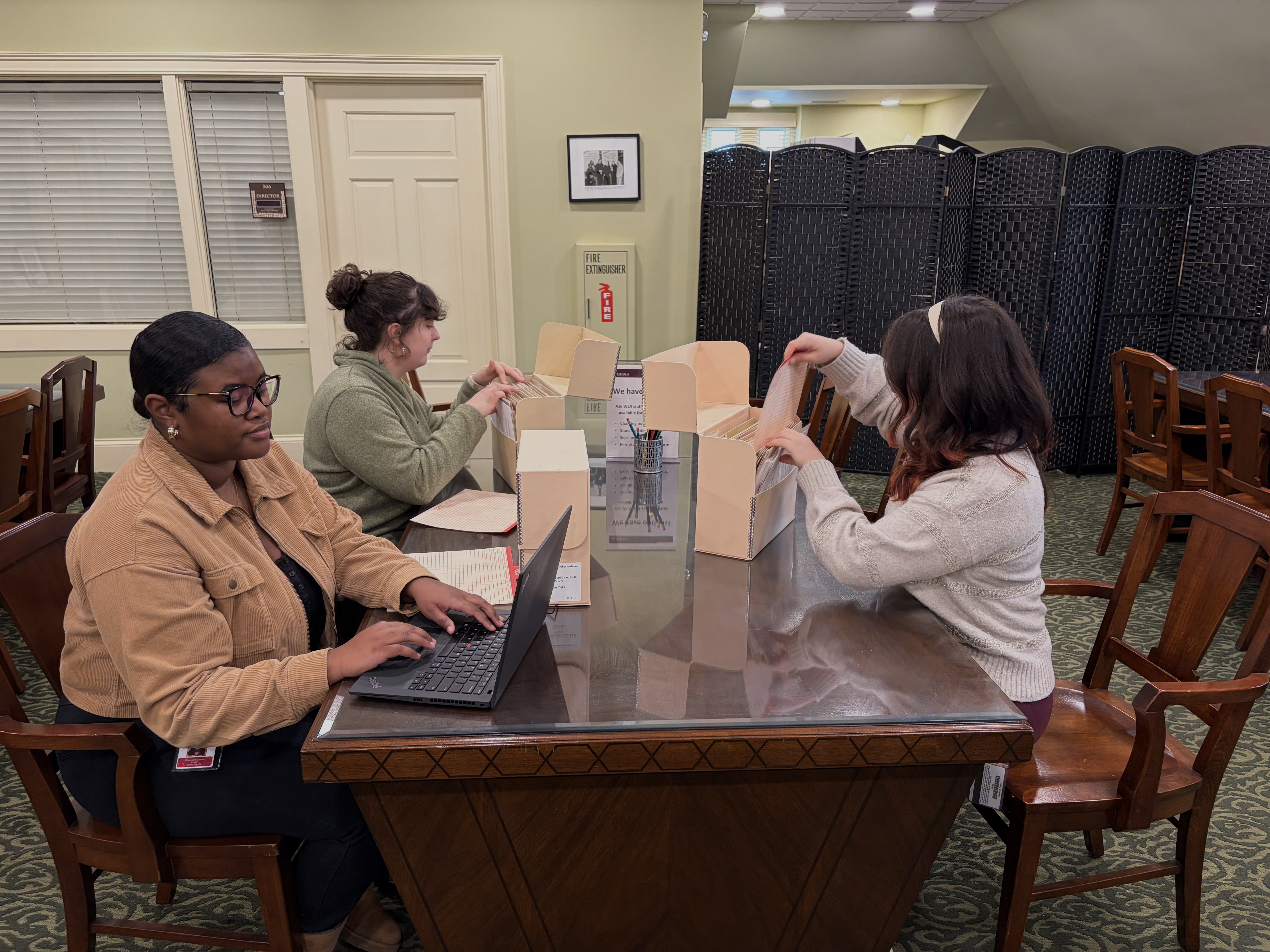 Researchers looking at archival materials in the WLA reading room