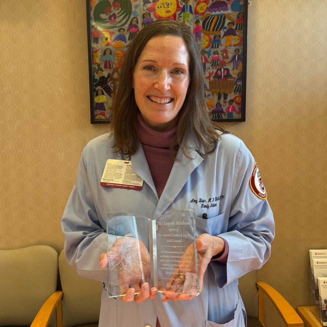 Amy Blair, MD, holding her Spirit of Dr. Martin Luther King, Jr. Award