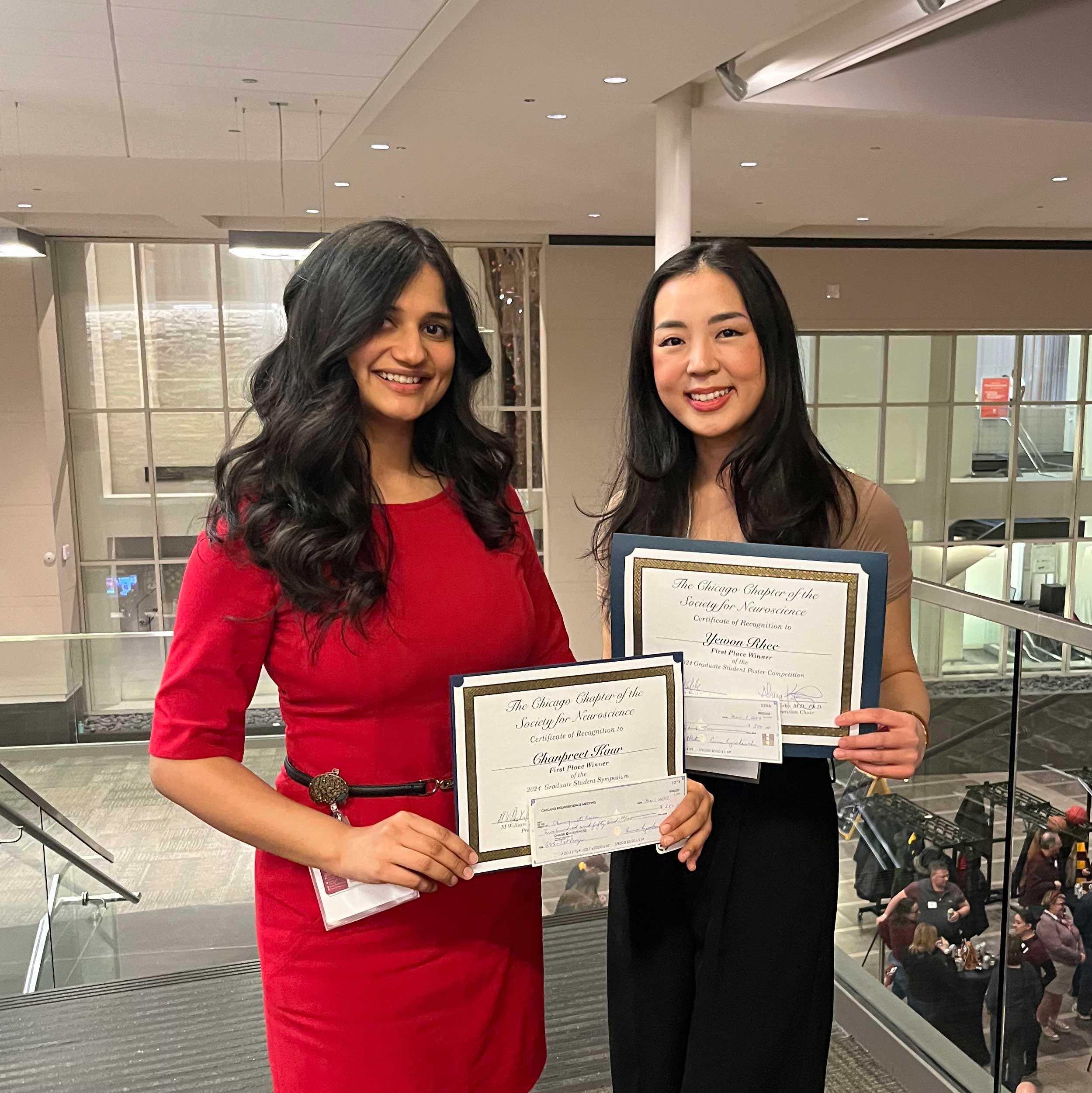 Chanpreet Kaur (left) and Yewon Rhee (right) hold certificates for winning competition